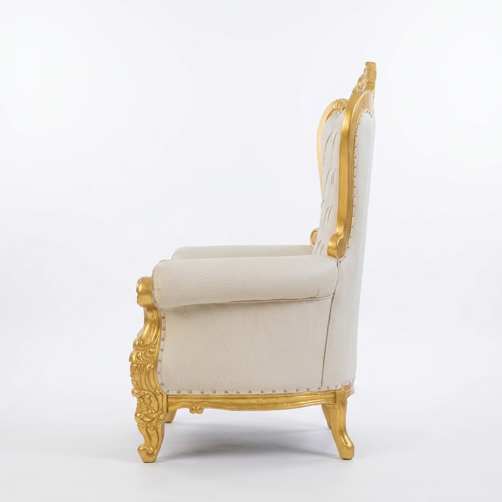 A single ornate armchair shown from the side against a plain white studio background. The chair has cream or off-white upholstered seating and a carved gold frame with nailhead trim and cabriole-style legs.