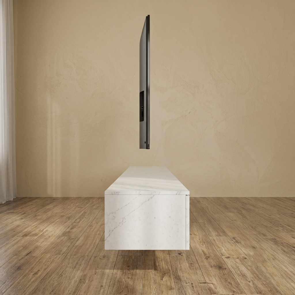 A floating white marble TV stand or console box is shown in a minimalist room with wood floors and a textured beige wall, with a slim black television suspended above it.