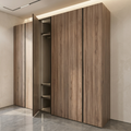 A modern built-in wardrobe or closet with wood-look doors in a warm medium brown tone, shown in a minimalist interior with light beige walls and gray floor.
