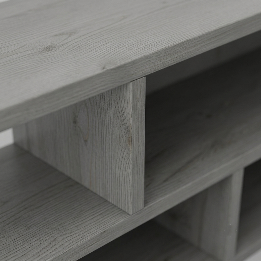 Close-up of a light gray wood storage shelf or cabinet corner with open cubby compartments and visible wood grain texture.