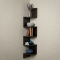 A dark brown corner wall shelf set with five nested L-shaped tiers, styled with a silver vase of dried lavender, a patterned ceramic bowl, books, a blue vase, a white flower, and a blue teapot, mounted on a textured beige wall.