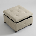 A square upholstered storage ottoman with a tufted lid, shown at a three-quarter angle on a light gray studio background.