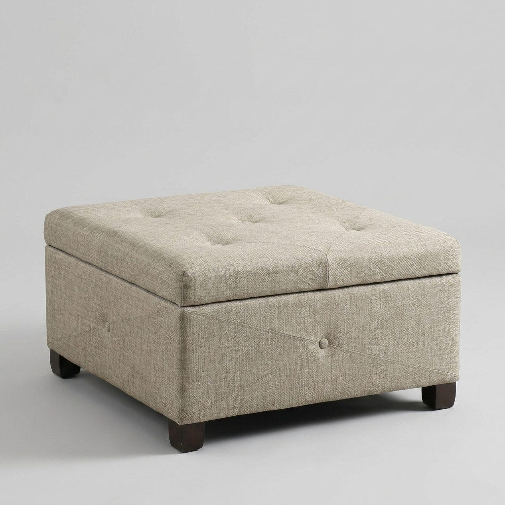 A square upholstered storage ottoman with a tufted lid, beige textured fabric, and dark wooden legs, photographed on a light gray studio background.