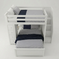 White wooden bunk bed with a pull-out lower bed, built-in side storage drawers, and a staircase on the right. The beds are styled with navy blue and gray striped bedding and solid navy pillows against a clean white background.