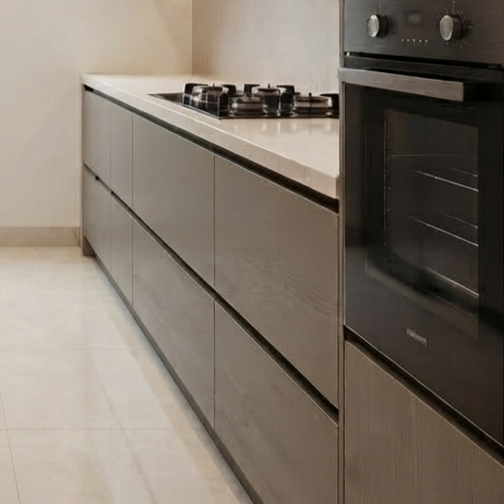 Modern kitchen cabinetry with matte taupe-gray wood grain drawers and a matching light stone countertop, featuring a built-in black gas cooktop and an integrated oven.