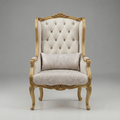 An ornate high-back wingback armchair with carved gold-finished wood framing and tufted cream upholstery, accompanied by a matching patterned lumbar pillow, photographed against a neutral gray studio background.
