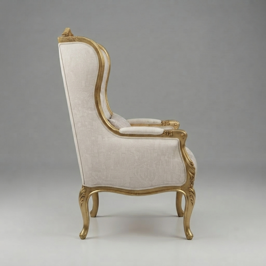A classic high-back wingback armchair with cream-colored fabric upholstery and ornate gold-gilded wooden frames, shown from a three-quarter angle against a neutral gray studio background.