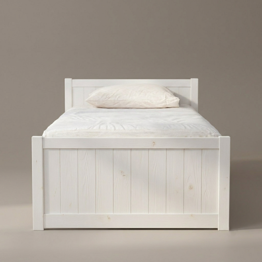 A white wooden single bed frame with a mattress and a white pillow, photographed against a plain warm gray studio background.